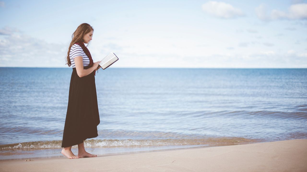 woman reading on beach